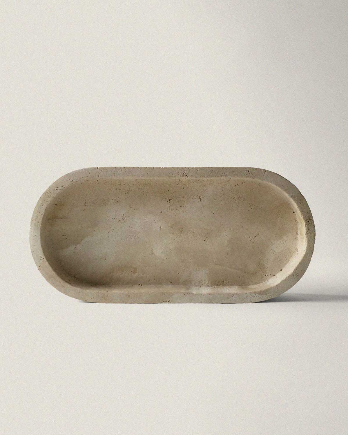Beige marble oval tray on a light background