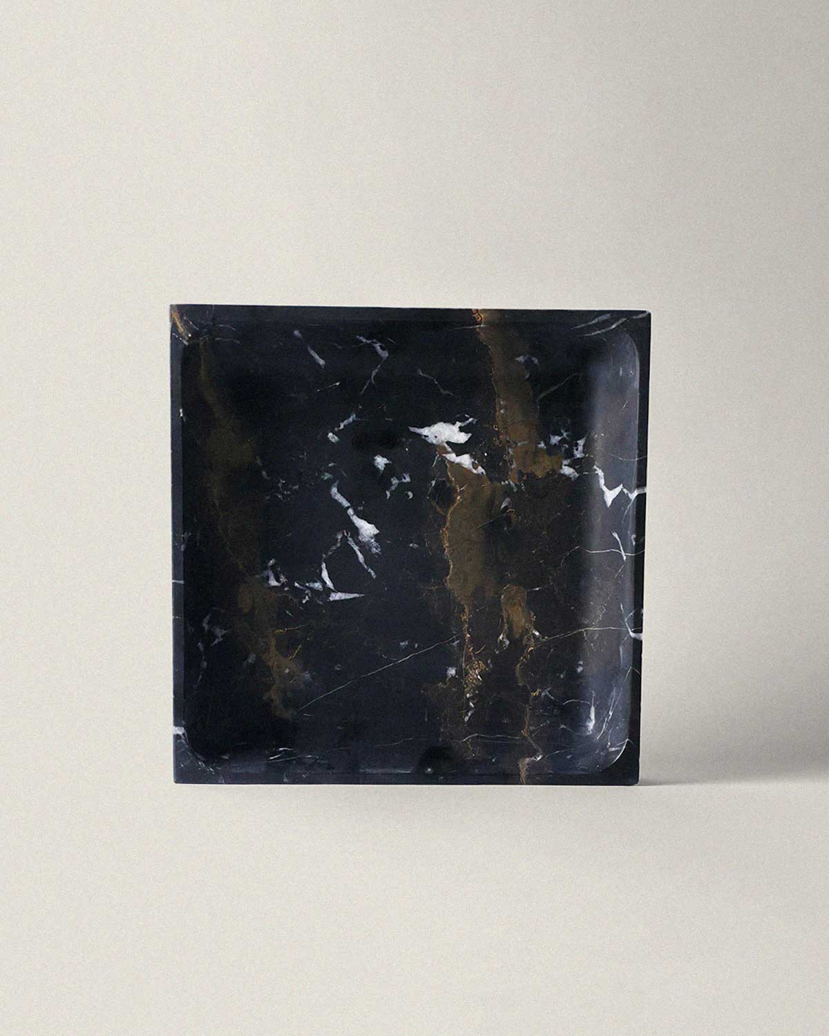 Square black marble tray on a light gray background