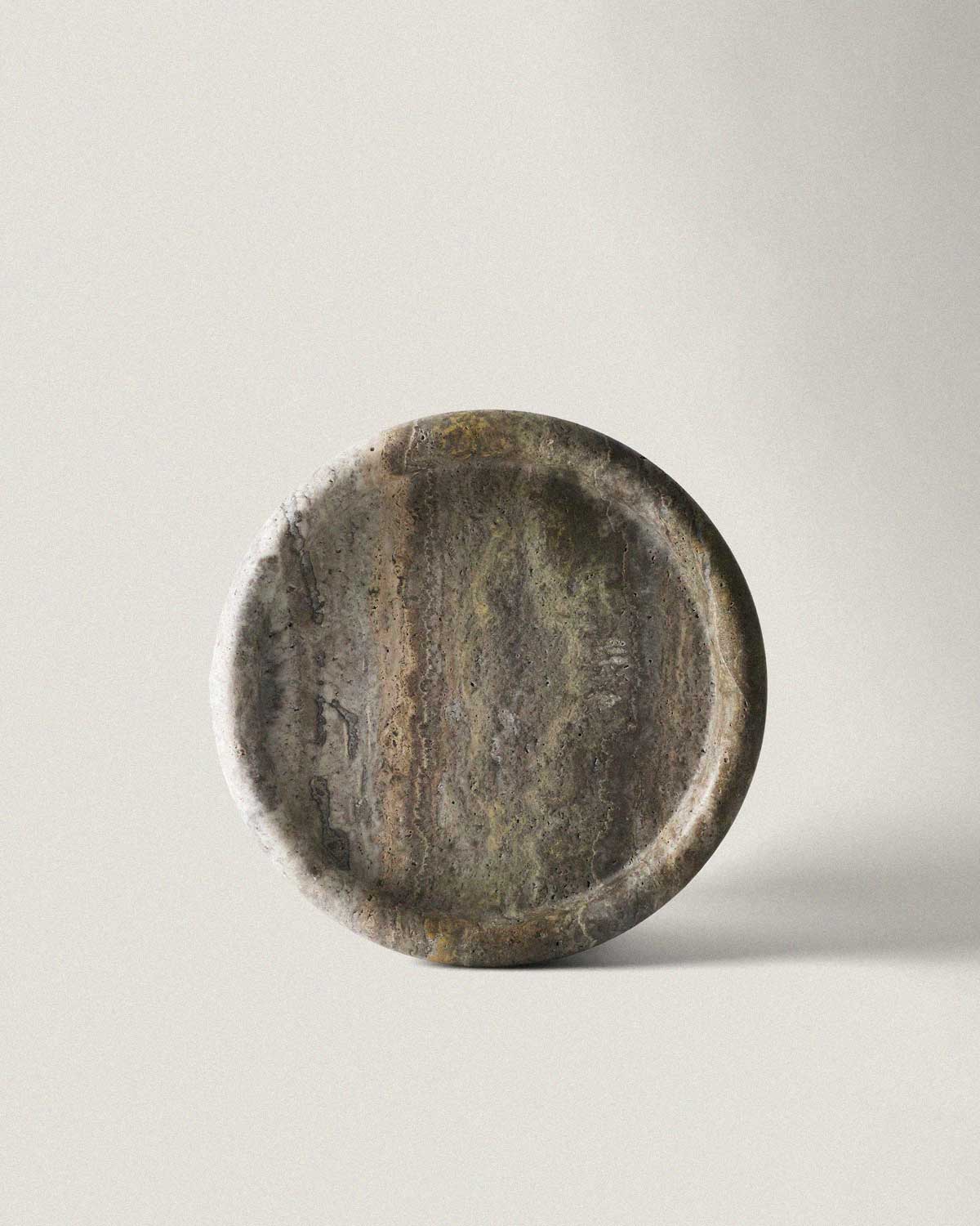 Grey marble catchall tray on a light gray background