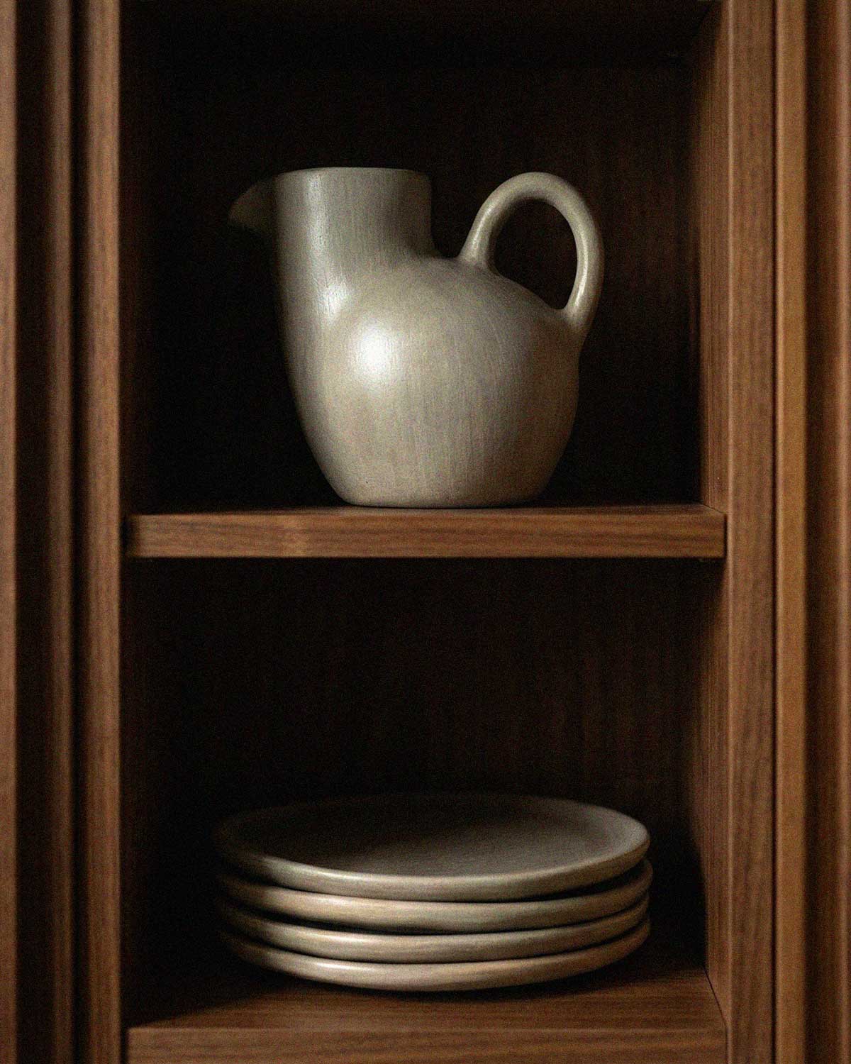 Handmade Mexican clay pitcher and matching plate set with a modern matte finish, authentic artisanal pottery styling.