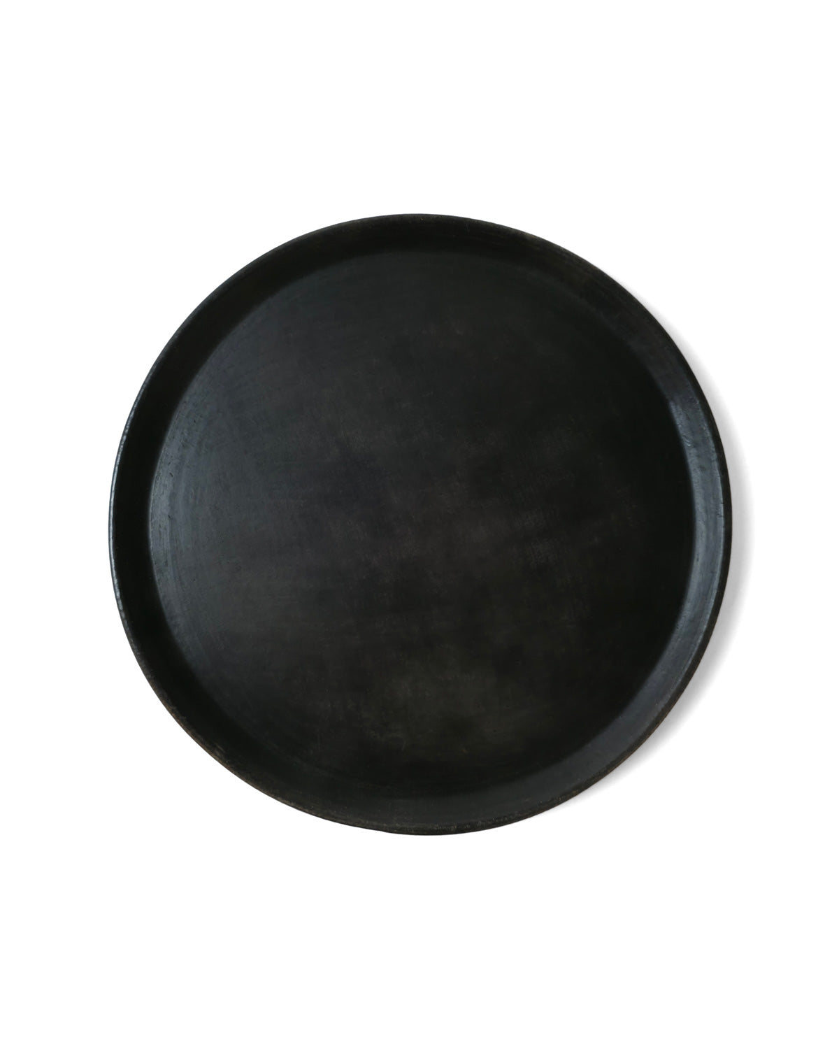Top view of Oaxacan black clay dinner plate.