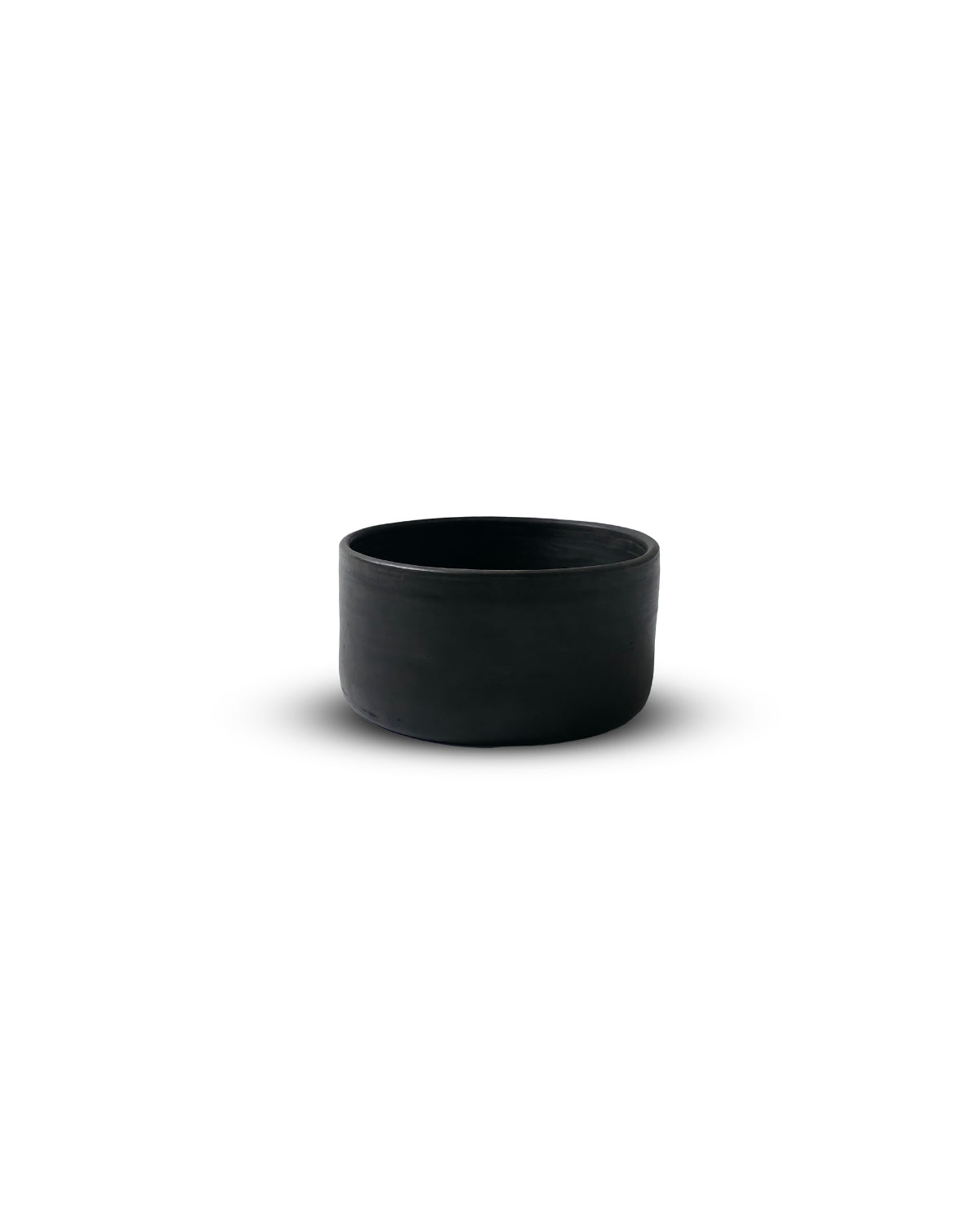 Side profile of Oaxacan black clay salsa bowl with straight walls and velvety matte finish.