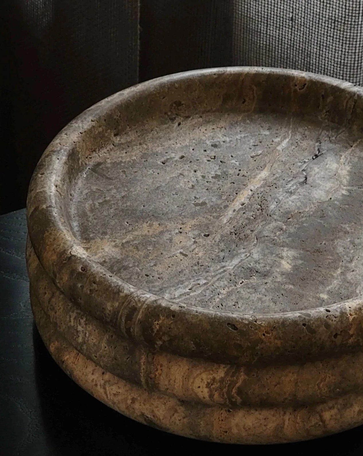 Close-up view of Seville Tray showcasing silver-grey travertine texture