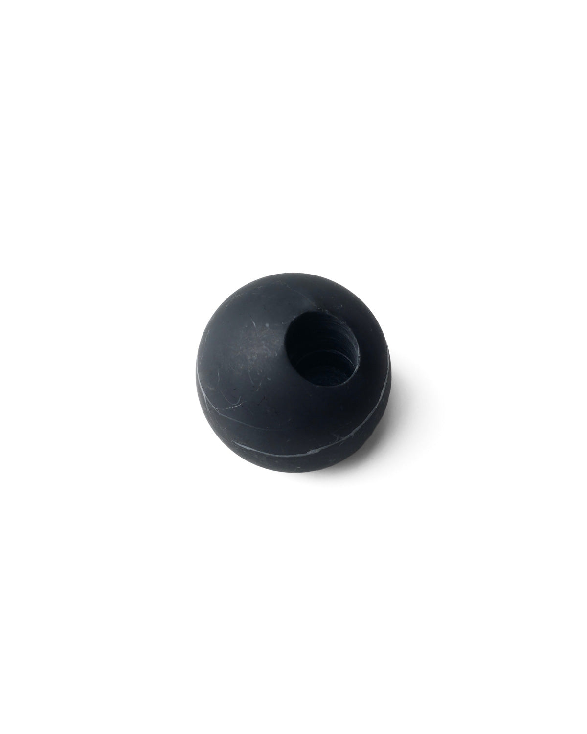 Top view of round black marble match holder with polished opening