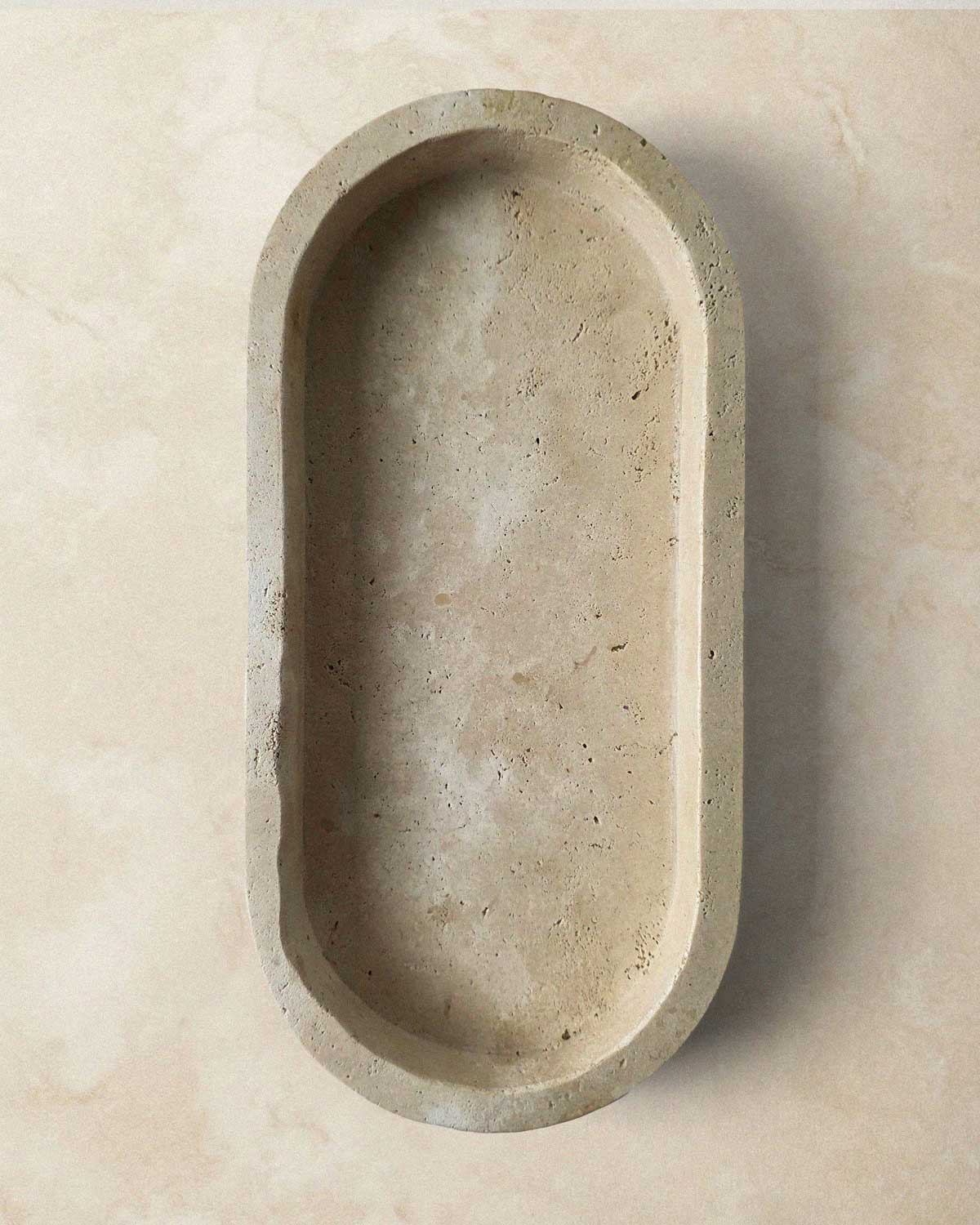 Beige marble oval tray on a beige background