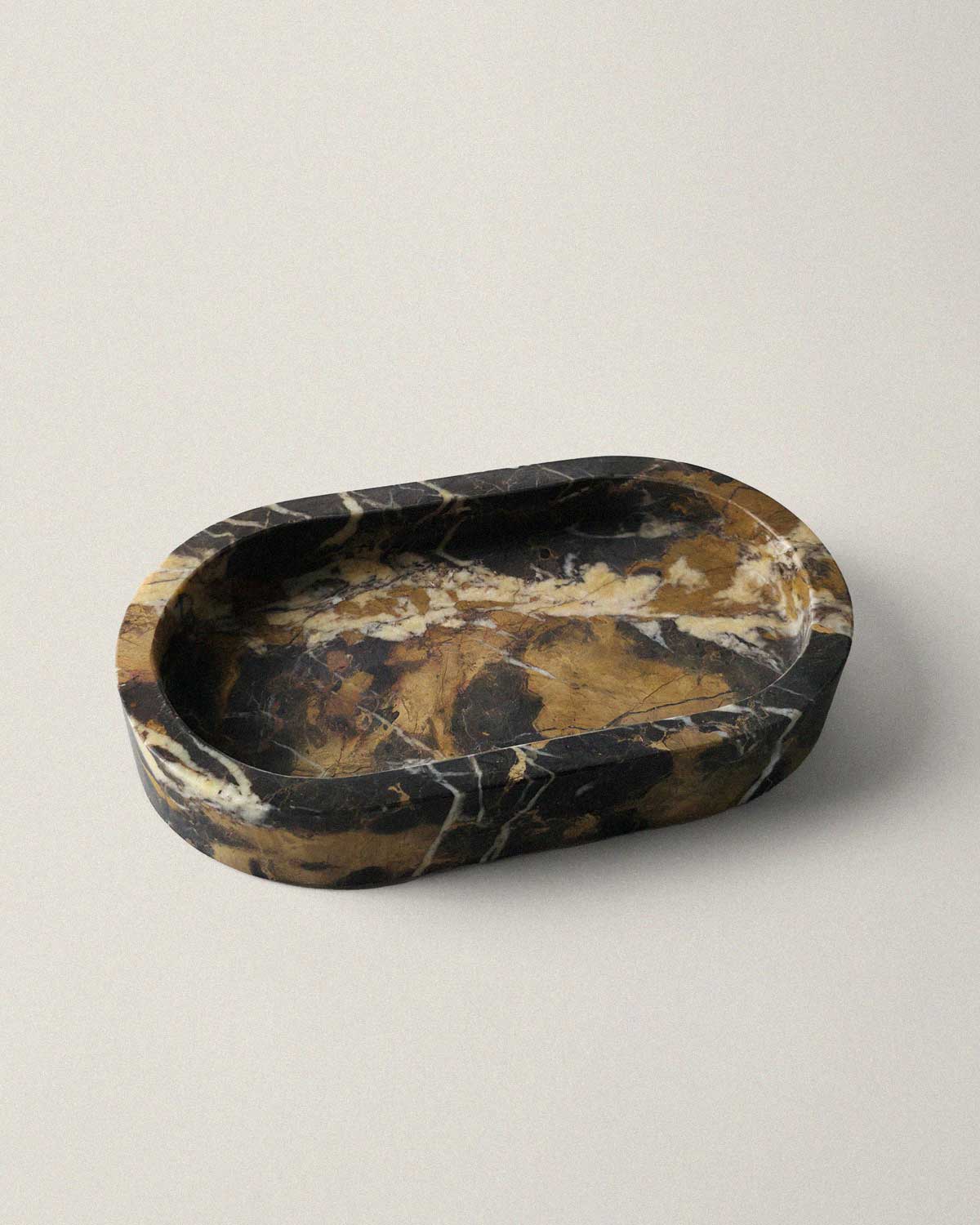 Black marble oval bathroom tray on a beige background