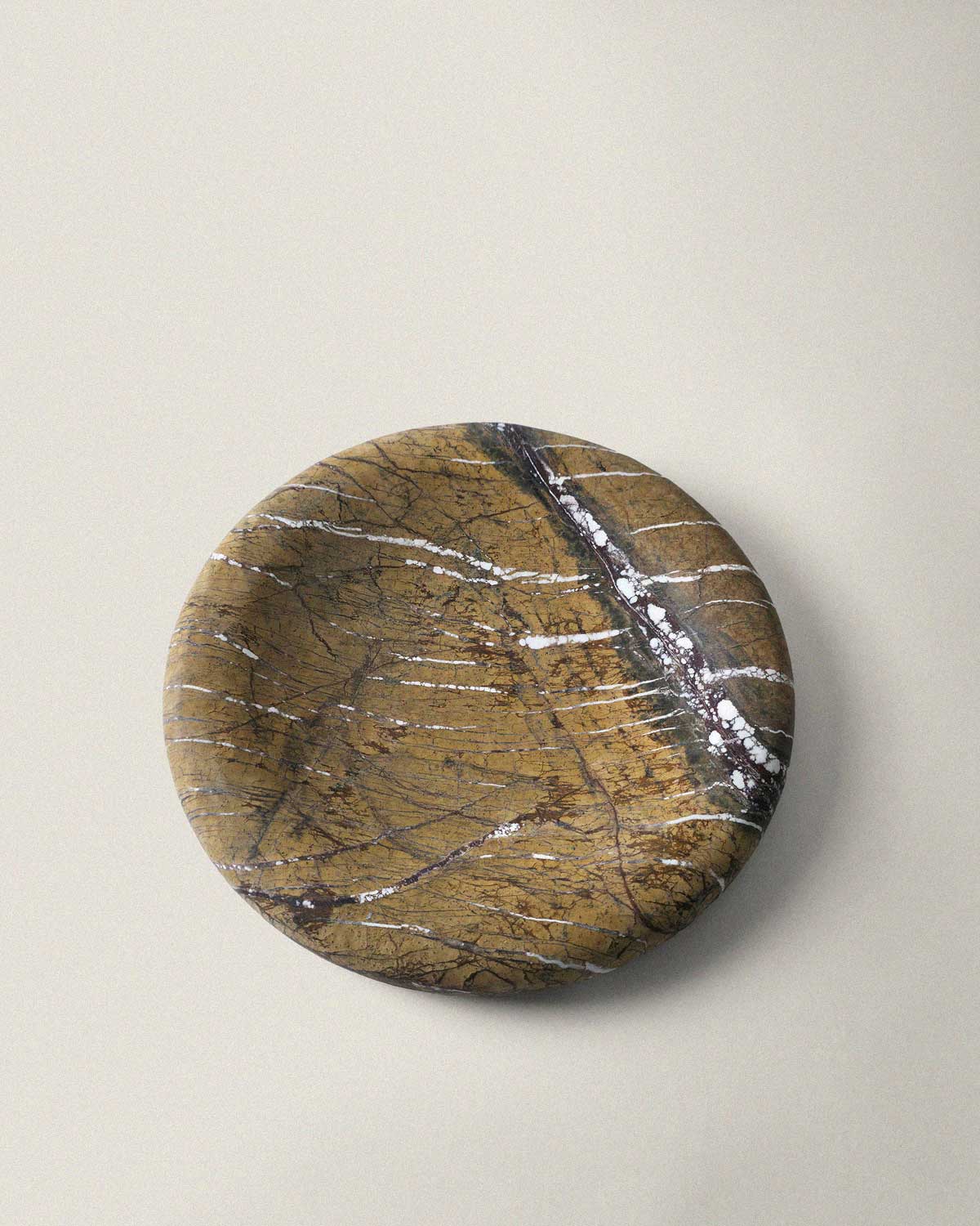 Brown marble decorative tray on a beige background