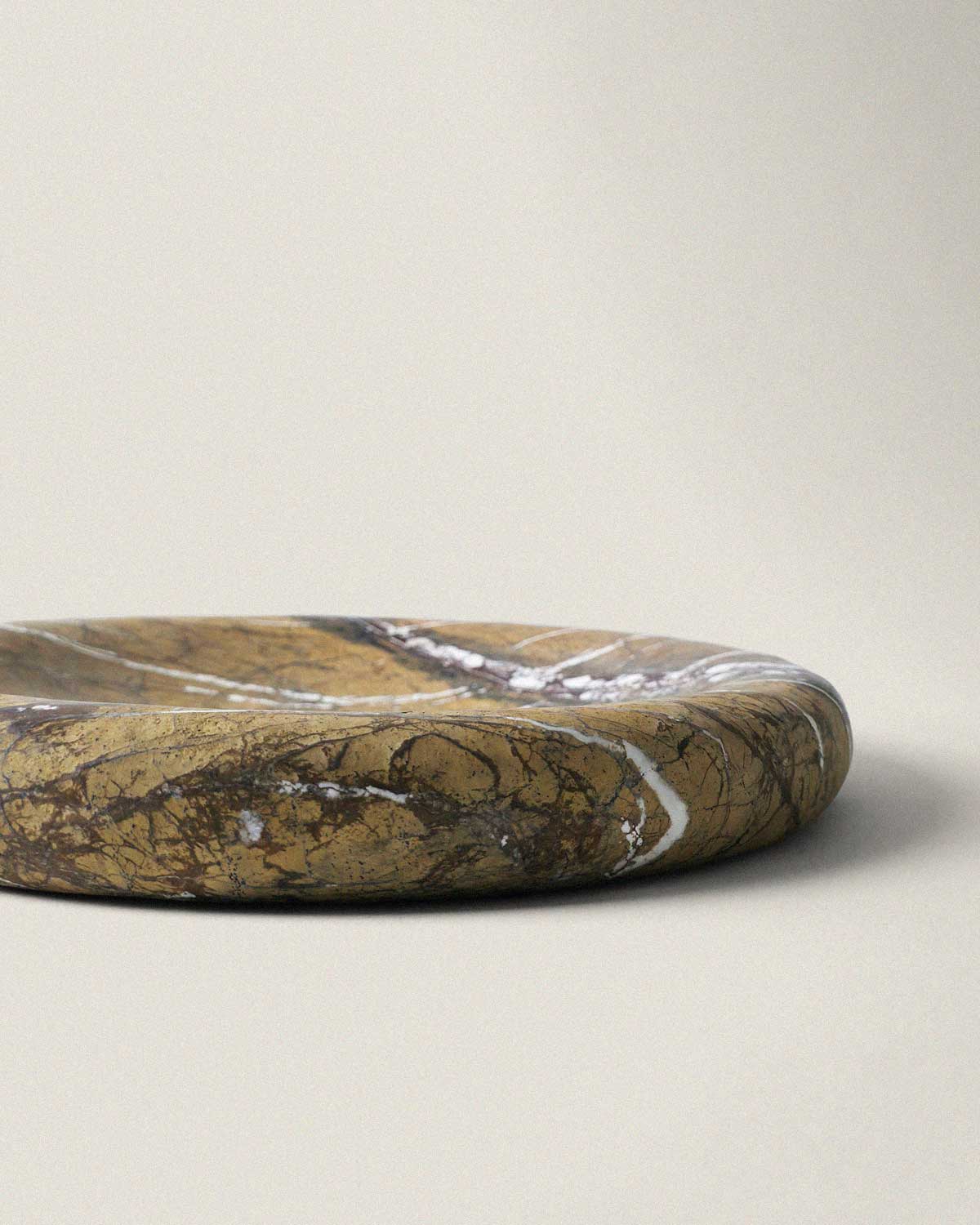 Brown marble decorative tray on a beige background