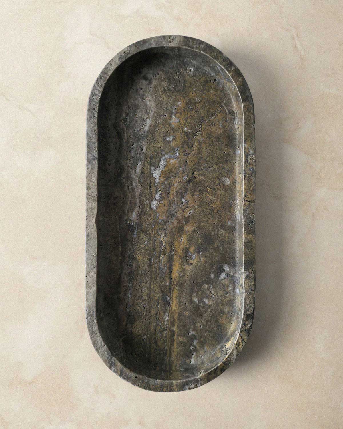 Oval marble grey tray on a beige background