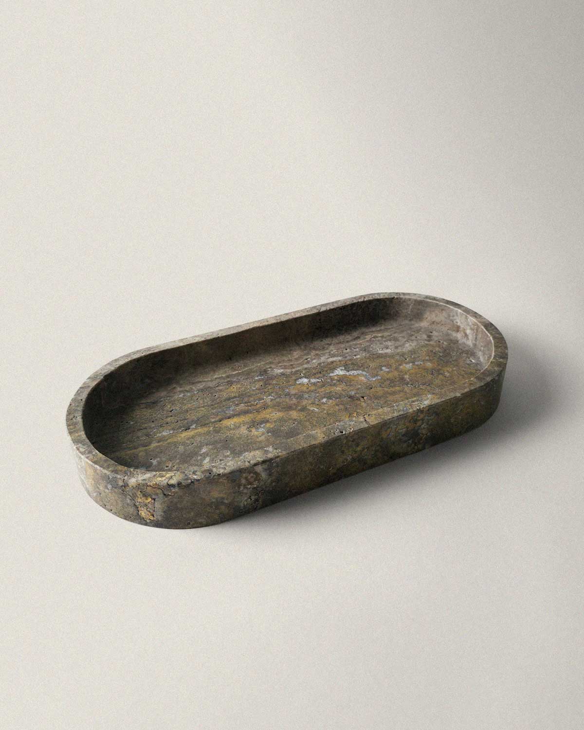 Oval marble grey tray on a beige background